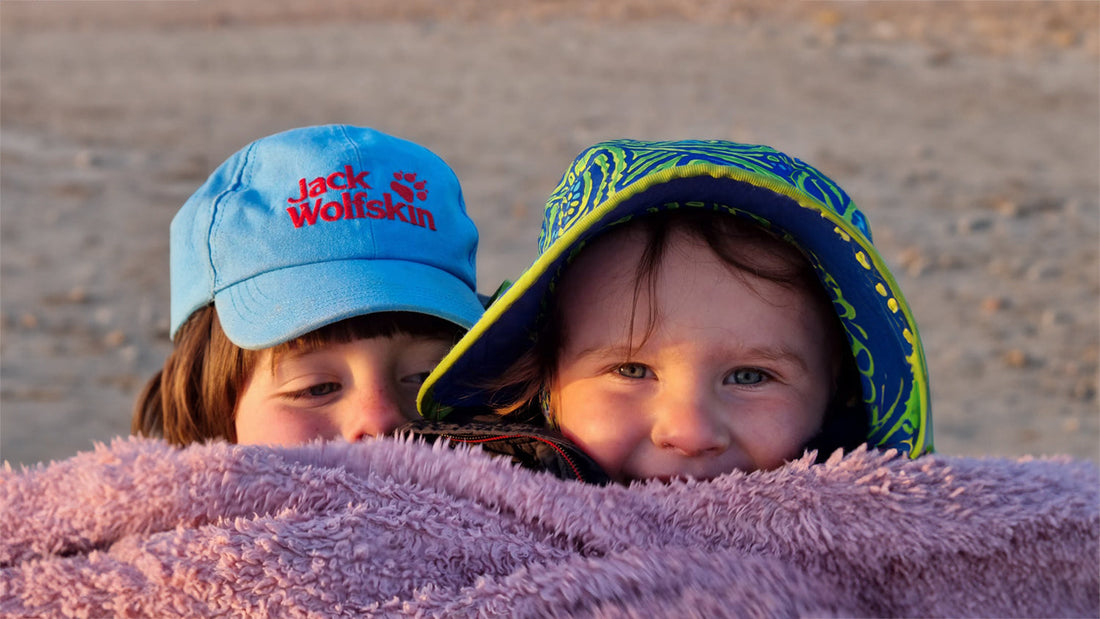 Kids on a beach wearing kids sun hats