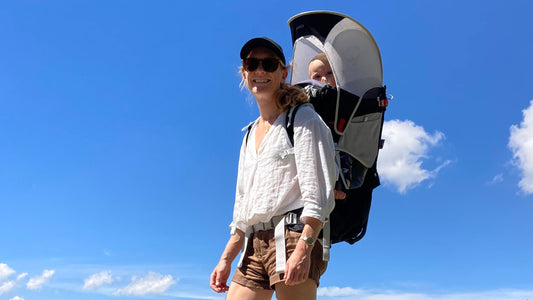 Woman walking with a baby backpack