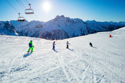 Kids skiing down a snowy slope