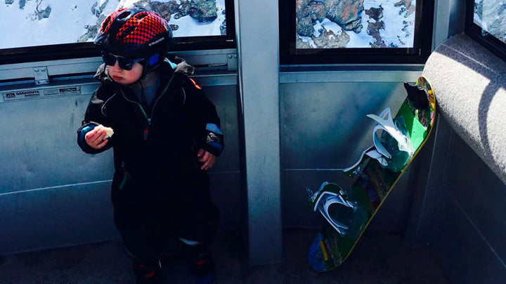 Toddler with snowboard